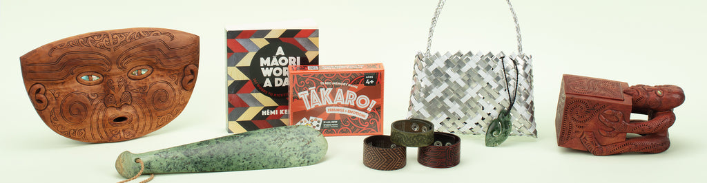 An image showing a range of Māori art and products available at Auckland Museum’s store, including pounamu (greenstone), wood carvings, aluminium kete by Anna Gedson and Takaro boardgame